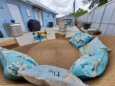 a wicker table with pillows on a patio at Relax 523 in Miami