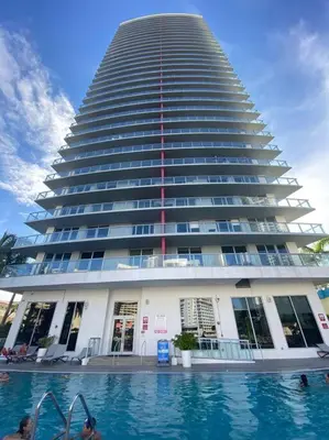 a large building with a swimming pool in front of it at Stylish Miami Beach Getaway, Ocean Views & Gourmet Kitchen -12A in Hallandale Beach