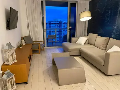 a living room with a couch and a table at Stylish Miami Beach Getaway, Ocean Views & Gourmet Kitchen -12A in Hallandale Beach