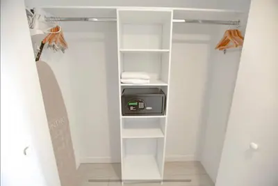 a walk in closet with white shelving at Cozy BeachWalk Nest 2 Full Beds, Steps to Ocean -2010B in Hallandale Beach
