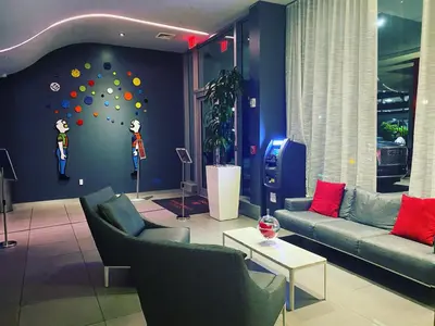 a living room with couches and a wall with a climbing wall at Cozy BeachWalk Nest 2 Full Beds, Steps to Ocean -2010B in Hallandale Beach