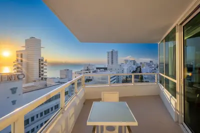 a balcony with a table and a view of the city at Fontainebleau Hotel Ocean View Fits 6! 1 BED/2 BA in Miami Beach