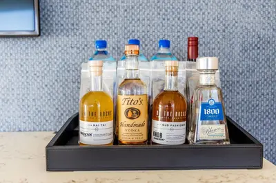 a tray with four bottles of alcohol on a table at Fontainebleau Hotel Ocean View Fits 6! 1 BED/2 BA in Miami Beach