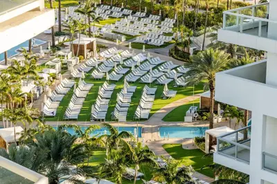 an aerial view of a resort with a pool and palm trees at Fontainebleau Hotel Ocean View Fits 6! 1 BED/2 BA in Miami Beach