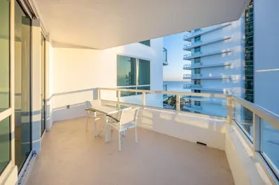 a balcony with a table and chairs and a building at Fontainebleau Hotel Ocean View Fits 6! 1 BED/2 BA in Miami Beach