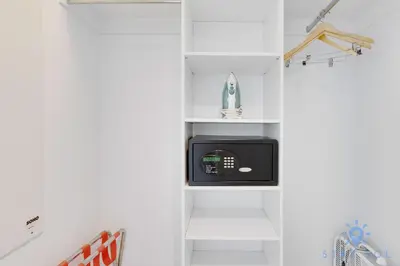a kitchen with white shelves and a microwave at Spacious 2BR Condo, Sleeps 6, Beachwalk Resort in Hallandale Beach