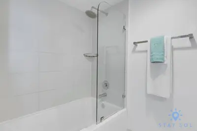 a shower with a glass door in a bathroom at Spacious 2BR Condo, Sleeps 6, Beachwalk Resort in Hallandale Beach