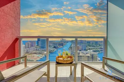 a balcony with a view of a city at Spacious 2BR Condo, Sleeps 6, Beachwalk Resort in Hallandale Beach