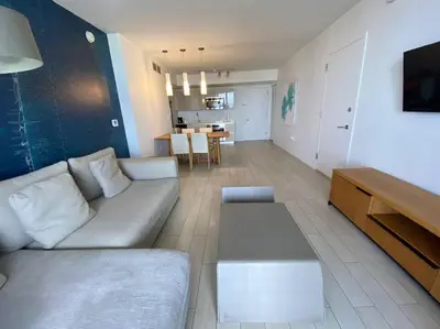 a living room with a white couch and a table at Boutique-Style Miami Apt, Comfort, Design & Sea View -26A in Hallandale Beach