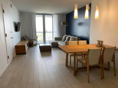 a living room with a table and a couch at Boutique-Style Miami Apt, Comfort, Design & Sea View -26A in Hallandale Beach