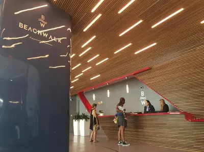a group of people standing at a bar in a restaurant at Miami Beach Glam, Ocean Views & Elegance -28B in Hallandale Beach