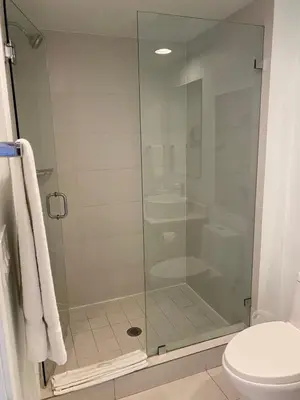 a glass shower in a bathroom with a toilet at Miami Beach Glam, Ocean Views & Elegance -28B in Hallandale Beach