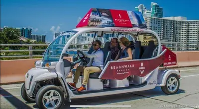a group of people riding in a golf cart at Miami Beach Glam, Ocean Views & Elegance -28B in Hallandale Beach