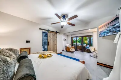 a bedroom with a bed and a ceiling fan at Pool and Waterfront Oasis in Fort Lauderdale