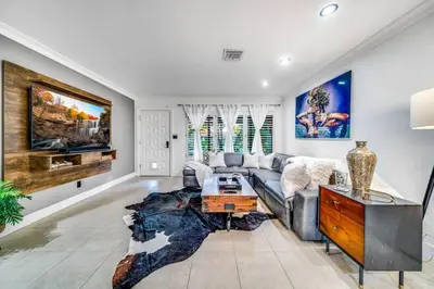 a living room with a couch and a table at Pool and Waterfront Oasis in Fort Lauderdale