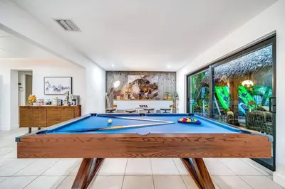 a pool table in a room with a large window at Pool and Waterfront Oasis in Fort Lauderdale