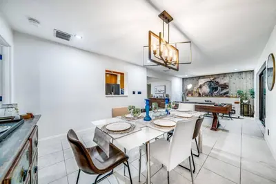 a kitchen and dining room with a table and chairs at Pool and Waterfront Oasis in Fort Lauderdale