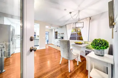 a kitchen and dining room with a table and a chair at Pool and Beach Relaxing Close to Everything in Dania Beach
