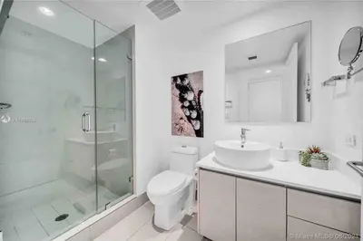 a bathroom with a toilet and a sink and a shower at Beachy Vibes Studio, 2 Full Beds, Near Everything -30B in Hallandale Beach