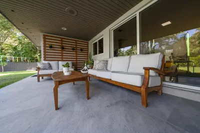 a porch with a white couch and a table at Boho House - Stylist Home with Parking and large Yard in Miami