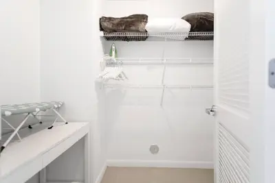 a room with white walls and a closet with a bed at Awesome Apt With Pool in Midtown Miami in Miami
