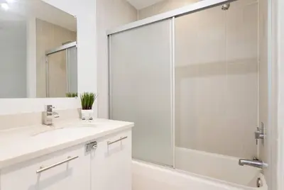 a bathroom with a sink and a glass shower at Awesome Apt With Pool in Midtown Miami in Miami