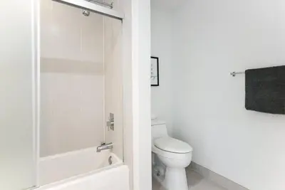 a white bathroom with a toilet and a shower at Awesome Apt With Pool in Midtown Miami in Miami
