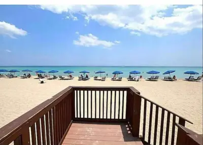 a beach with chairs and umbrellas on the sand at The Tides! On the beach, Sea view! in Hollywood