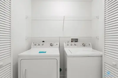 a white kitchen with a stove and a dishwasher at Apartment with Balcony, Gym & Near Beach in Hallandale Beach