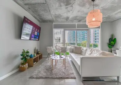 a living room with a white couch and a table at Amazing Condo with Pool at Midblock Miami in Miami