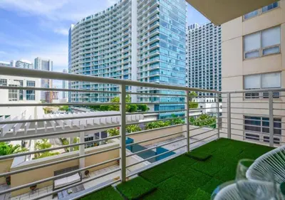 a balcony with a view of a tall building at Amazing Condo with Pool at Midblock Miami in Miami