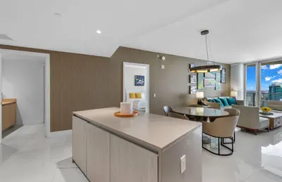 a living room with a table and a dining room at Lyfe Oceanview Resort Luxury 2 Bedroom Unit in Hollywood