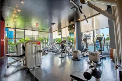 a gym with a bunch of treadmills and machines at Chic Beach Studio Walk to Shore Sleeps 4 -14B in Hallandale Beach