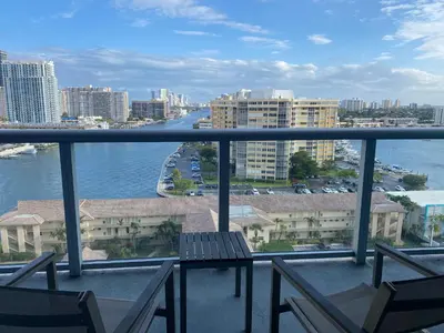 a balcony with chairs and a view of the water at Chic Beach Studio Walk to Shore Sleeps 4 -14B in Hallandale Beach