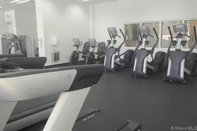 a gym with a row of exercise bikes in a room at High Floor Unit Located in Brickell - Free Parking in Miami
