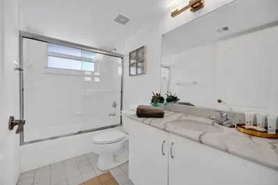 a white bathroom with a toilet and a sink at 40th Floor Priceless Unit Central Location in Miami