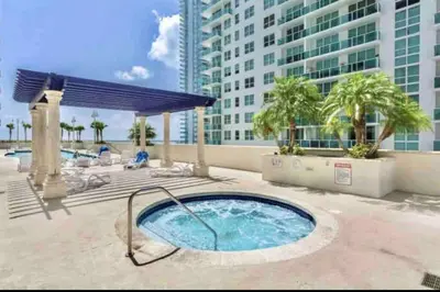 a hot tub on a patio with a building at High Floor Ocean view Unit In Brickell in Miami