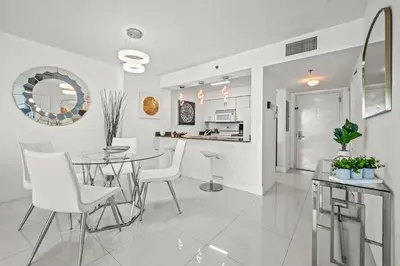 a kitchen and dining room with a table and chairs at High Floor Ocean view Unit In Brickell in Miami