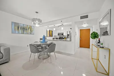 a white living room with a table and chairs at Amazing location W Parking in Miami in Miami