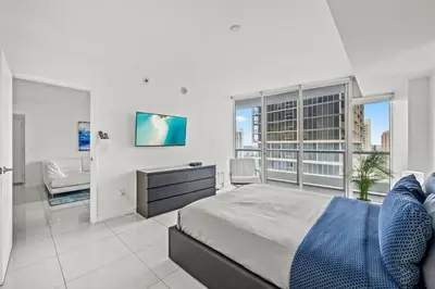 a bedroom with a large bed and a television at Iconic Icon W Unit - Pool & Ocean Views in Miami