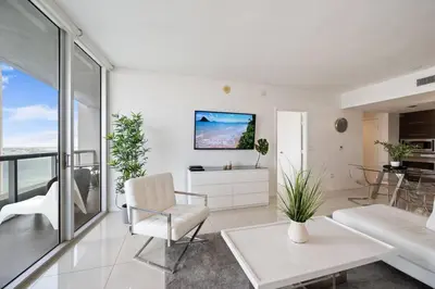 a living room with white furniture and a view of the ocean at Iconic Icon W Unit - Pool & Ocean Views in Miami