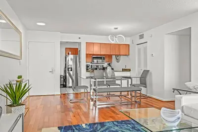 a living room with a table and a kitchen at INCREDIBLE OCEAN VIEW 3 BEDROOMS UNIT in Miami