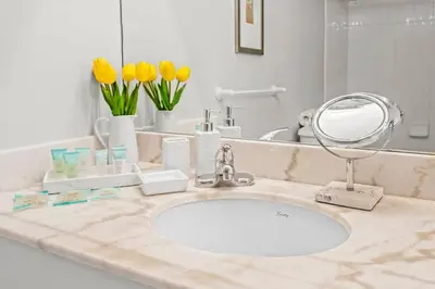 a bathroom counter with a sink and a mirror at INCREDIBLE OCEAN VIEW 3 BEDROOMS UNIT in Miami
