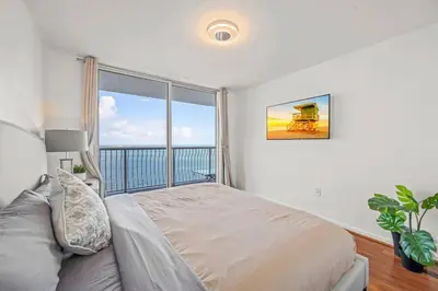 a bedroom with a bed and a large window at INCREDIBLE OCEAN VIEW 3 BEDROOMS UNIT in Miami