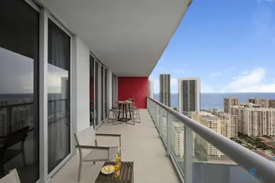 a balcony of a building with a view of the ocean at Infinite View - Balcony- Amazing Pool- Near Beach in Hallandale Beach