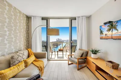 a living room with a couch and a table at Infinite View - Balcony- Amazing Pool- Near Beach in Hallandale Beach
