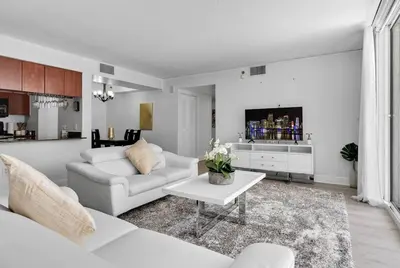 a living room with a white couch and a table at Modern 2/2 with Beautiful Ocean and Brickell Views in Miami