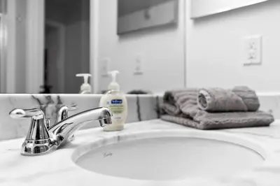 a bathroom sink with a faucet and a mirror at Modern 2/2 with Beautiful Ocean and Brickell Views in Miami
