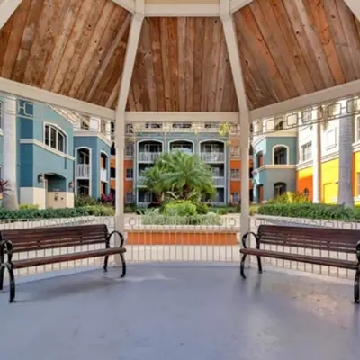 two benches in a pavilion with buildings in the background at Beautiful Apartment with Pool in Miami in Miami