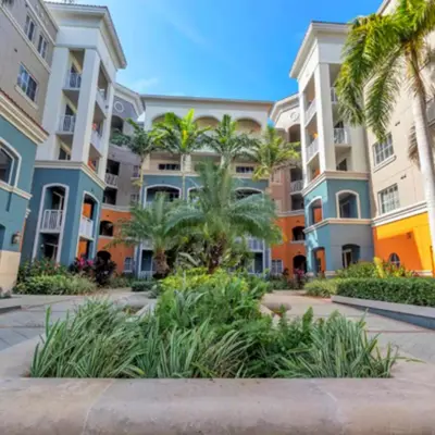 a row of apartment buildings with palm trees at Beautiful Apartment with Pool in Miami in Miami